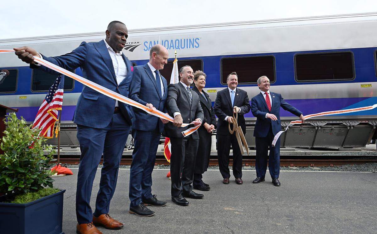 Officials welcome the new passenger cars with a ribbon-cutting as Amtrak showed off its new Venture coaches for its San Joaquins line at the ACE Rail Maintenance Facility in Stockton, Calif., Tuesday, March 5, 2024.