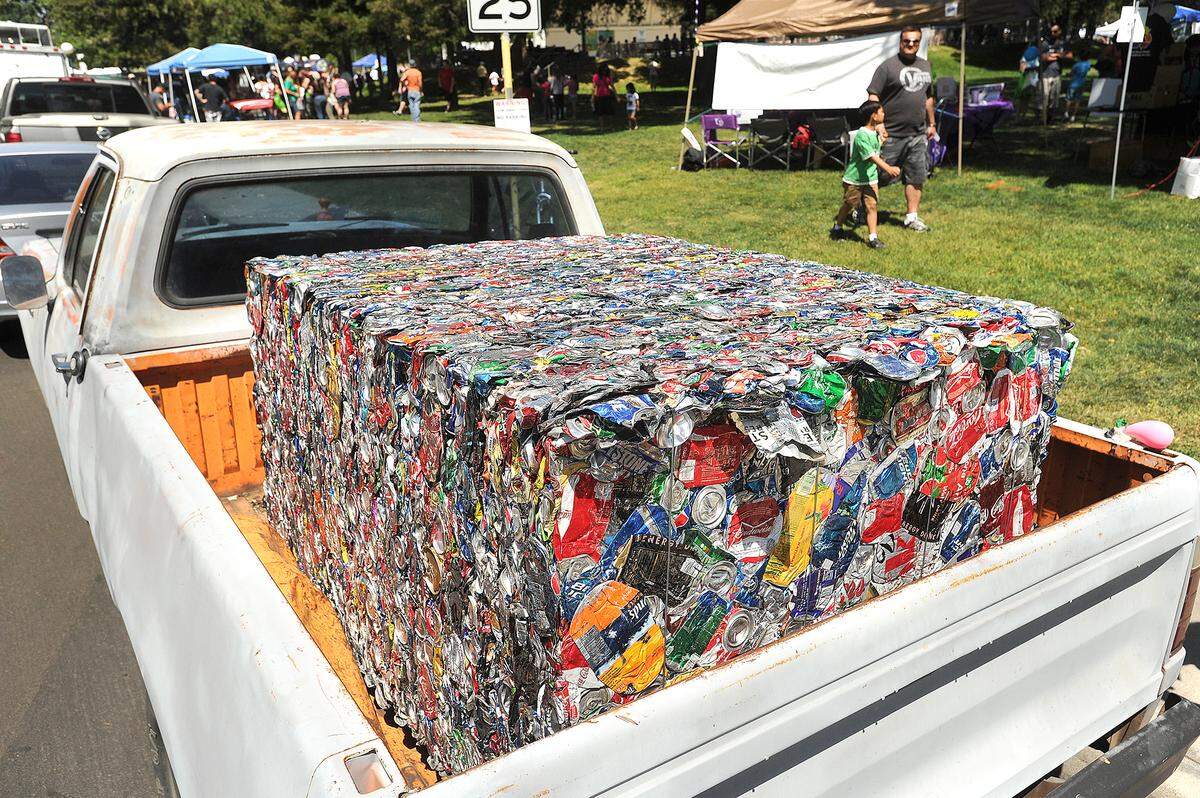 A cube of crushed aluminum cans sits in the back of a pickup during a past year’s Earth Day at Graceada Park.