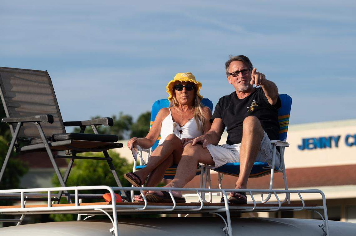 Scott Seward and Michele Downing sit atop a 1962 Volkswagen bus to watch the Graffiti Parade from McHenry Village shopping center in Modesto, Calif., Friday, June 9, 2023.