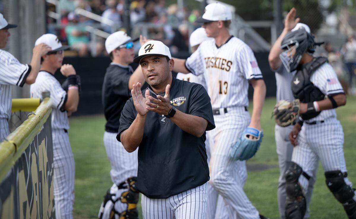 Hughson head coach Charly Garza cheers the team defensive effort during the Trans-Valley League game with Hilmar at Hughson High School in Hughson, Thursday, April 17, 2025.