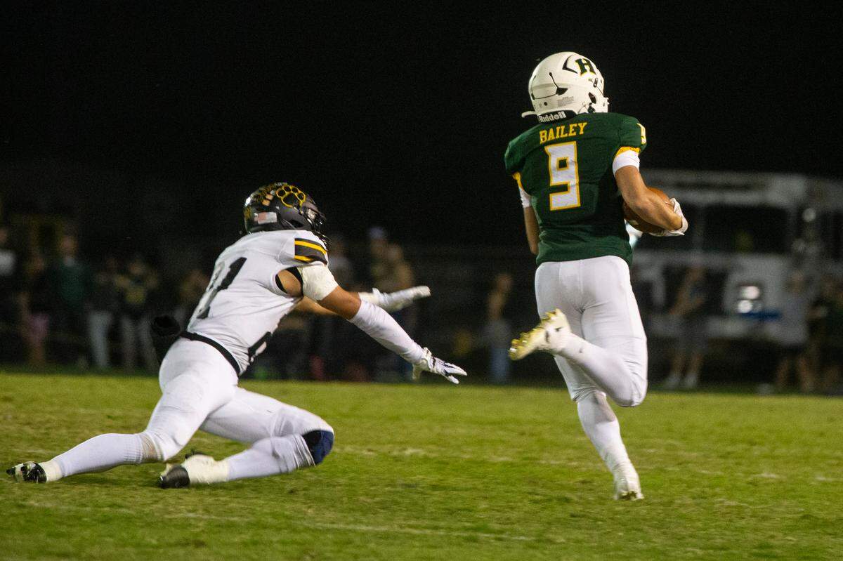 Caden Bailey, 9, of Hilmar High breaks free from Hughson defensive line for a 71 yard touchdown run during one quarter Friday Oct. 20, 2023 at Hilmar.