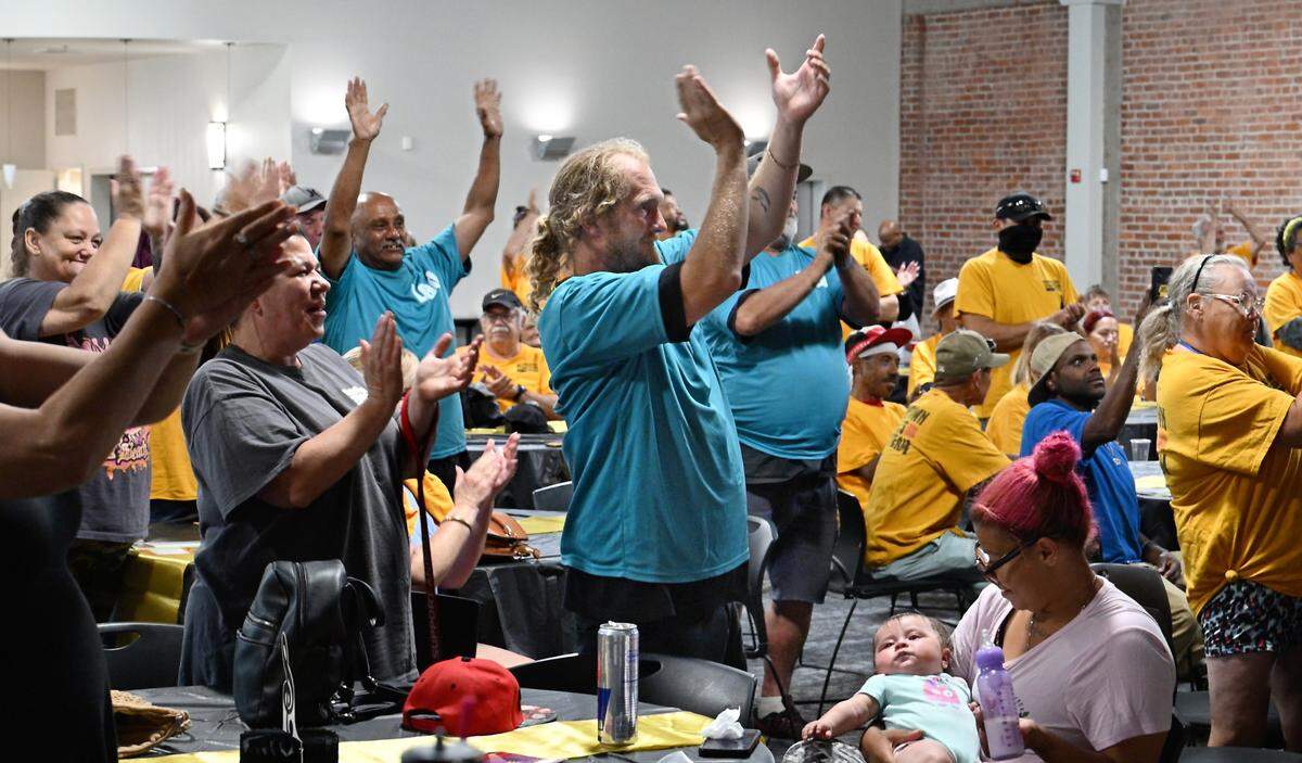 Members of the Downtown Streets Team cheer for team member Art Englin as he performs in the talent show at the Martin G. Petersen Events Center in downtown Modesto, Calif., Friday, May 31, 2024.