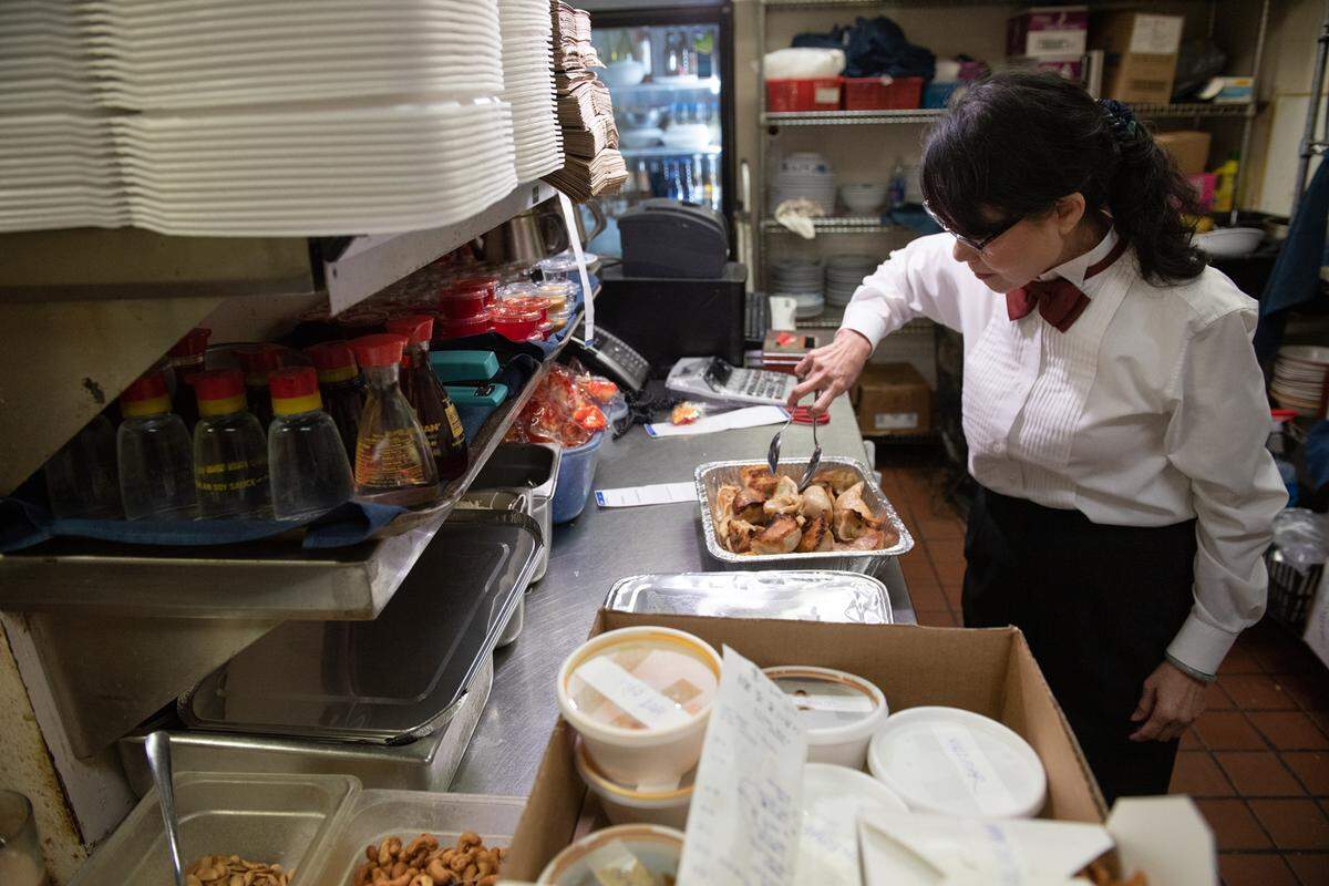 Owner Maria Wong prepares a catering order at Beijing Restaurant in Modesto, Calif., Thursday, Dec. 15, 2022.