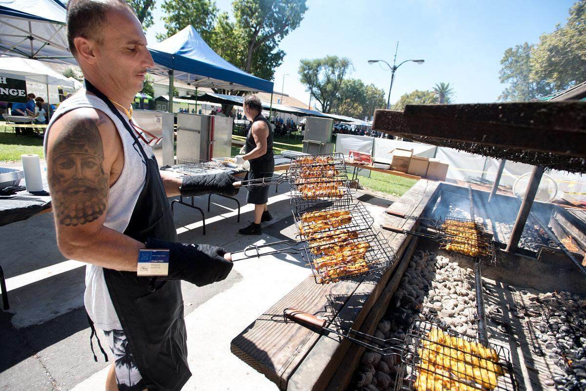 Gilbert Narsa grills chicken kabobs during the Assyrian Festival in Turlock, Calif., on Saturday, Sept. 15, 2018.