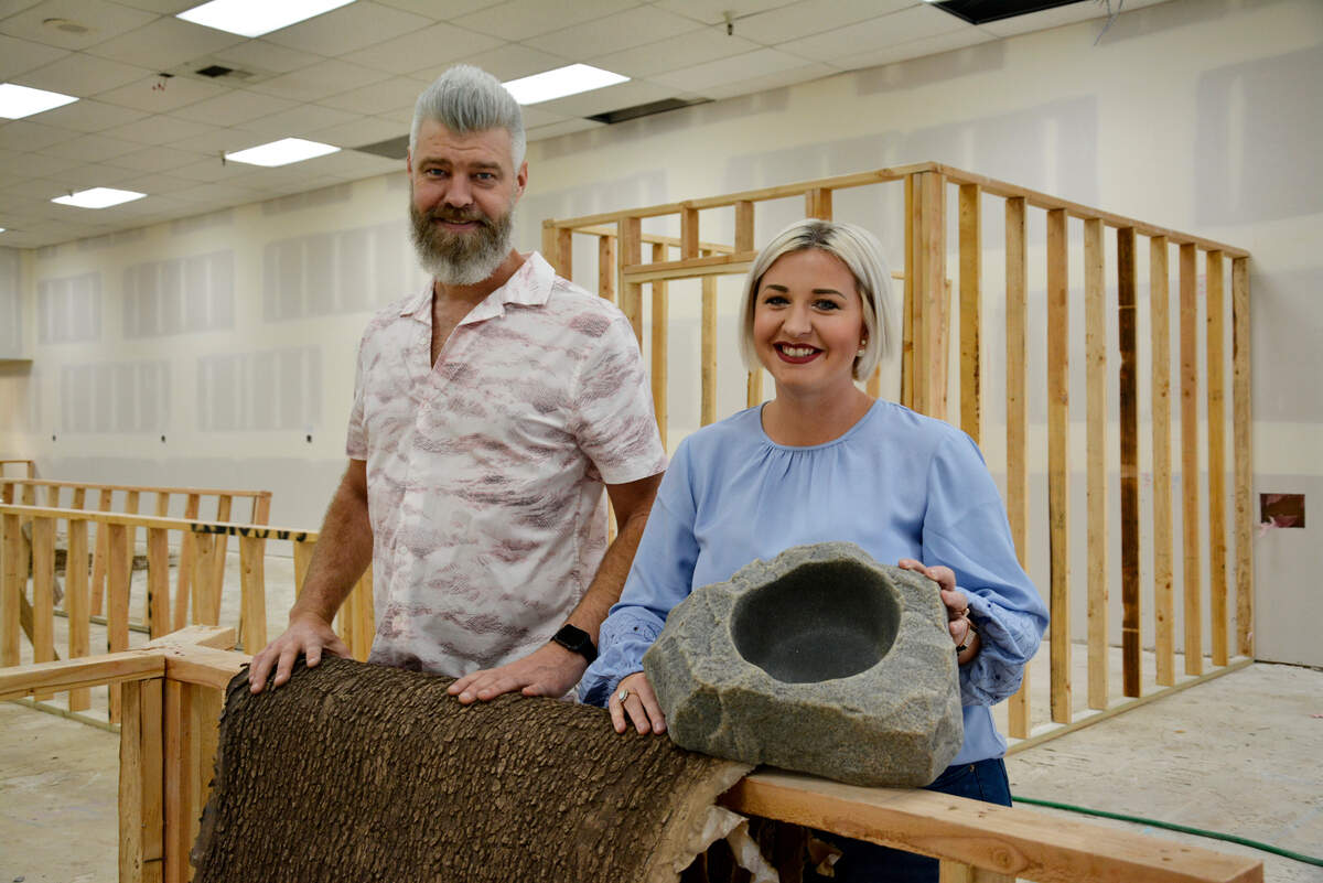 Siblings Mike Day and Elora Jordenson pose inside the site of their new planned indoor dog park and taproom in Modesto, Calif. March 2, 2022.