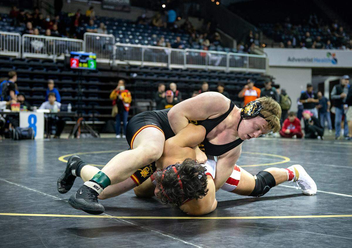 Garrison Gerber of Oakdale claimed fifth place with a pin of Folsom’s Enzo Mezoui in the 220-pound match during the CIF Sac-Joaquin Section Masters Wrestling Tournament at the Stockton Arena in Stockton, Calif., on Saturday, Feb. 19, 2022.