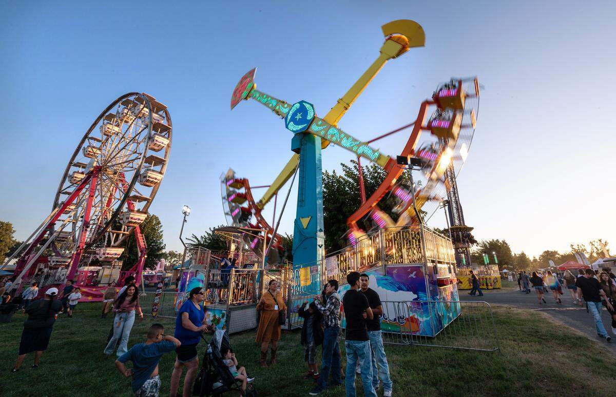 Midway rides at the Stanislaus County Fair in Turlock, Calif., Friday, July 7, 2023.