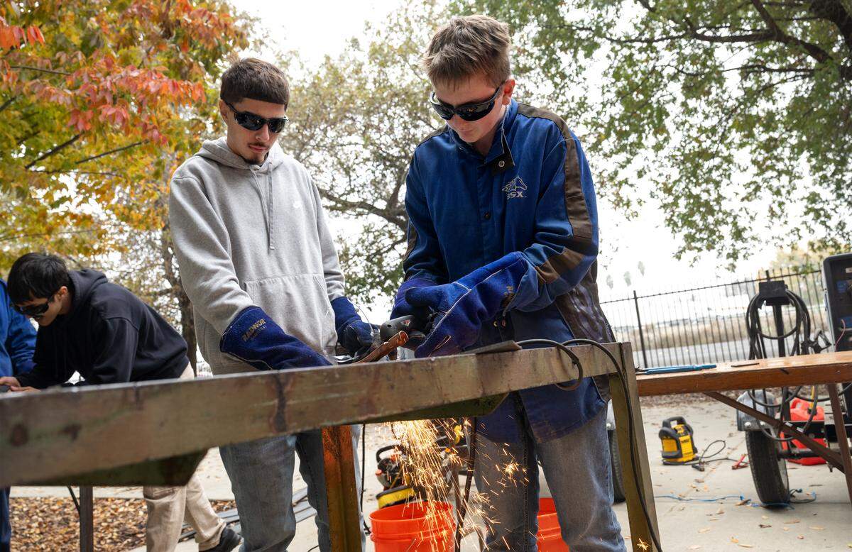 Enochs senior Isaiah Maestas, left, oversees Roosevelt Junior High student Stylz Harris cutting steel plate during a career-readiness event on the Modesto Junior College West Campus on  Tuesday, Dec. 2, 2025. 