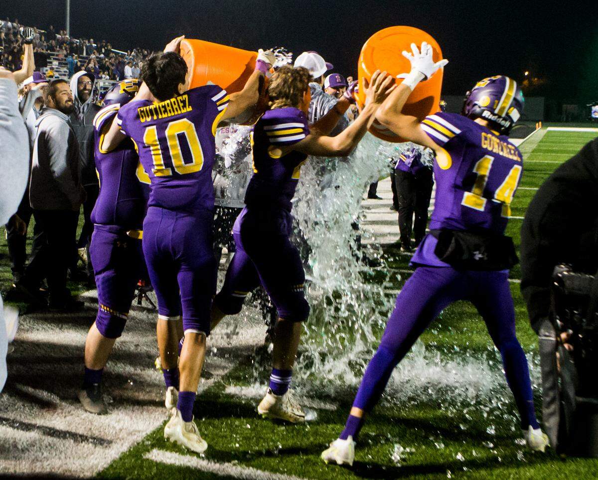 Escalon High head coach gets an ice bath from the players as they celebrate their win over Hilmar. Escalon High School took on Hilmar High football during the 2021 CIF Sac-Joaquin Football Playoffs - Division V at Saint Mary’s High School in Stockton, Ca. Escalon came out on top as the champions with a 20-13 win over Hilmar.