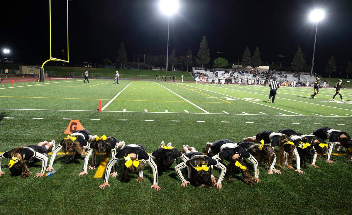 Enochs cheerleaders do pushups after an Eagles touchdown during the game with Buhach Colony at Gregori High School in Modesto, Calif., Friday, Sept. 1, 2023. Enochs won the game 54-8.