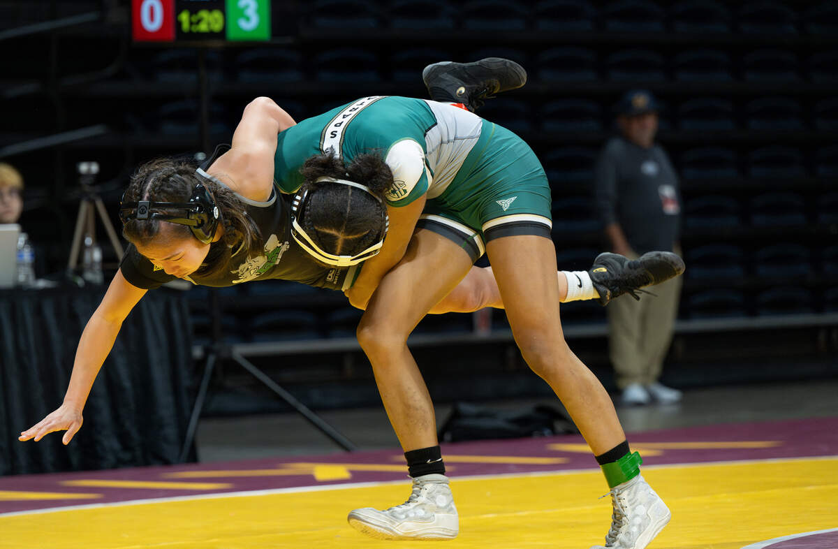 Grace Davis’ Jazmine Turner takes down Lauren Catiis from Twelve Bridges in the 105-pound title match during the Sac-Joaquin Section Masters Wrestling championships at Adventist Health Arena in Stockton, Saturday, Feb. 22, 2025.