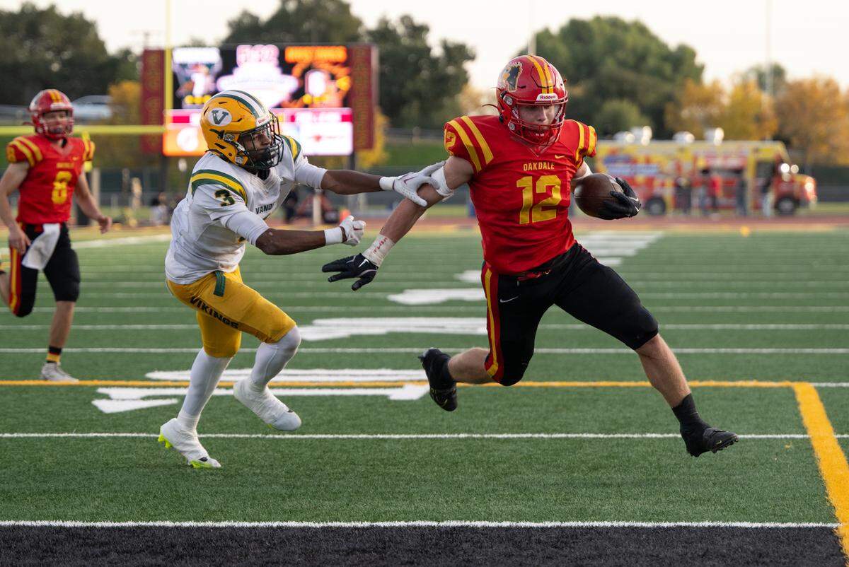 Oakdale’s Wes Burford scores on a run past Vanden’s Jamarion Grace during the Sac-Joaquin Section Division 3 championship game at Sacramento City College in Sacramento, Saturday, Nov. 30, 2024. Burford carried the ball 33 times for 226 yards and three touchdowns.