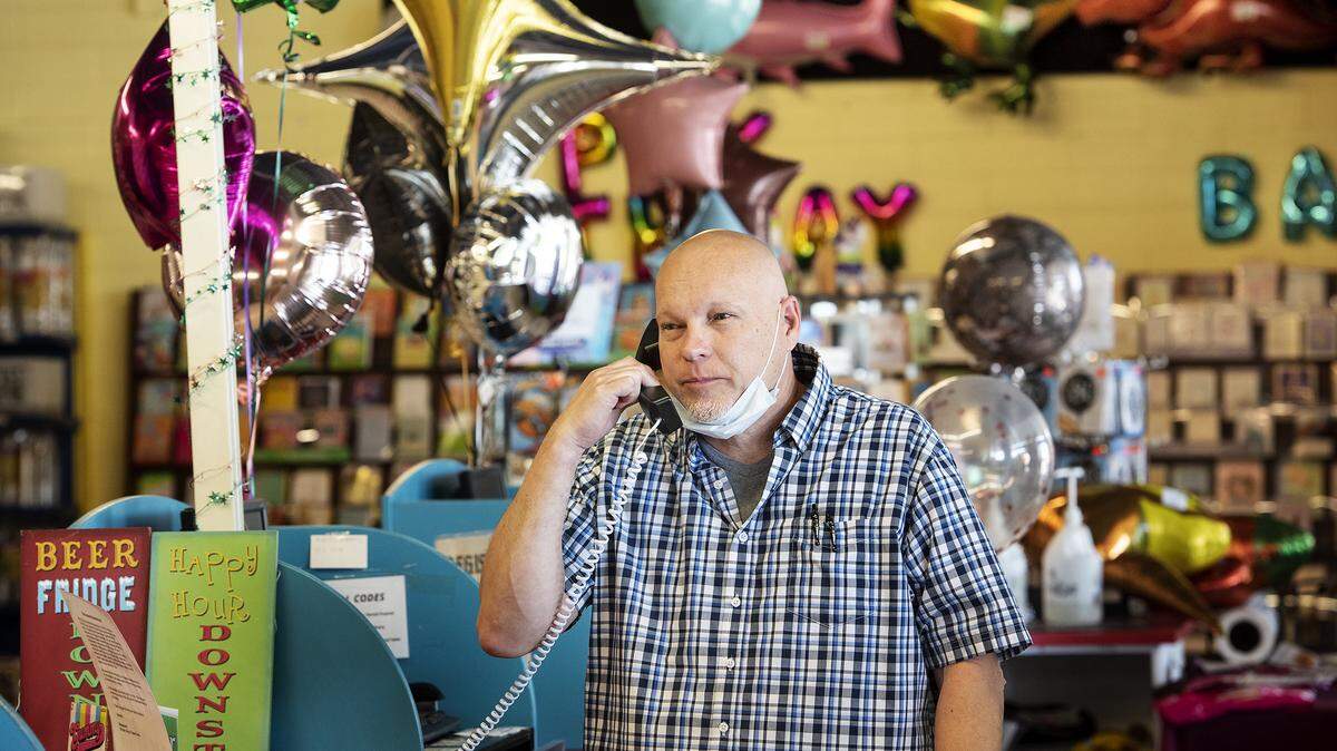 Grand Events owner Ray Pogue talks with a customer stating that he will be open for business Friday for curbside orders at Grand Events in Modesto, Calif., on Thursday, May 7, 2020.