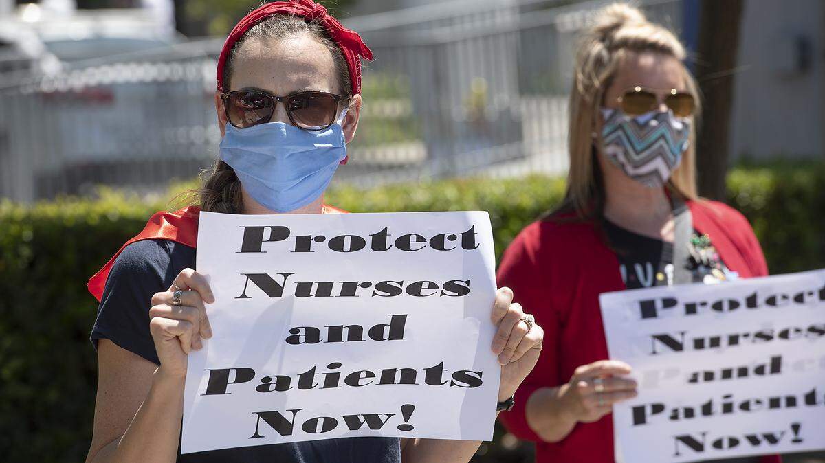 ICU nurse Rosemary Amaral, left, and fellow nurses at Emanuel Medical Center join 139 nationwide May Day actions demanding COVID-19 protections for nurses and other health care workers in Turlock, Calif., on Friday, May 1, 2020.