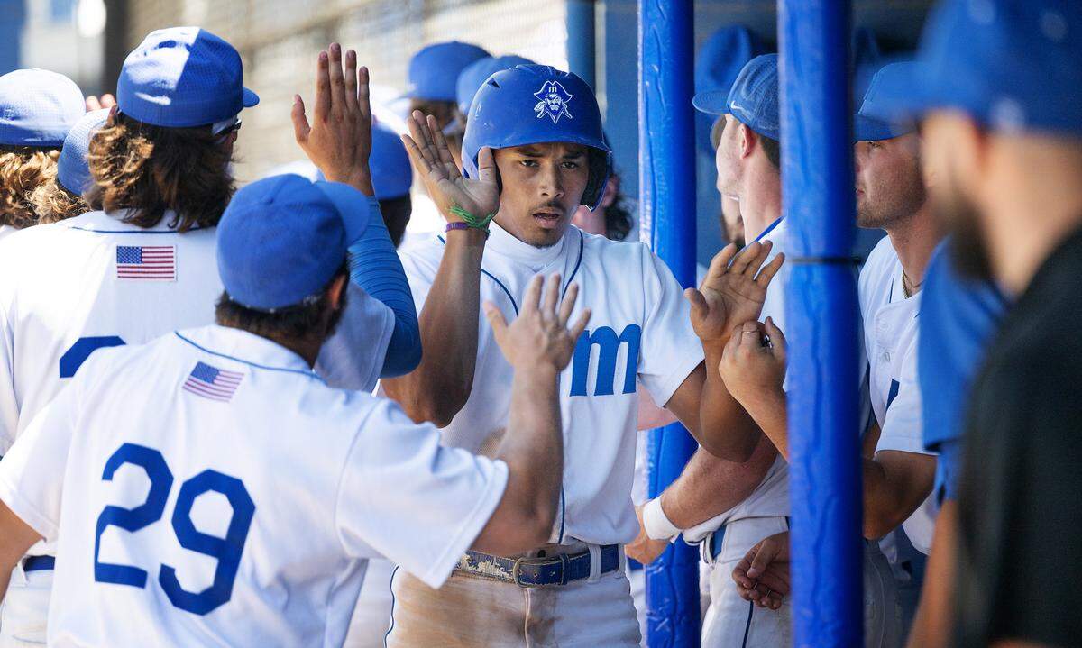 Modesto’s Paul Contreras is greeted by teammates after scoring during the 3C2A NorCal Regional playoff game with Sacramento City College at Modesto Junior College in Modesto, Calif., Friday, May 3, 2024. Modesto won the game 6-3.