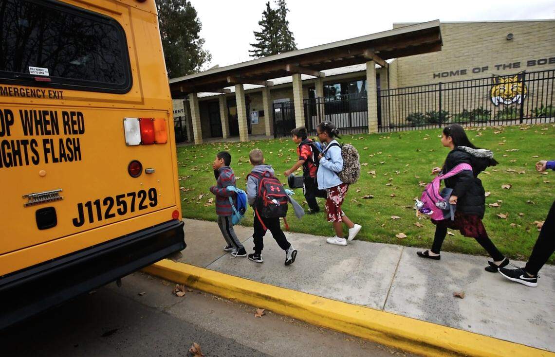 Students board a bus after school at Bonita Elementary School in Crows Landing, Calif., on Wednesday, Dec. 18, 2019. 