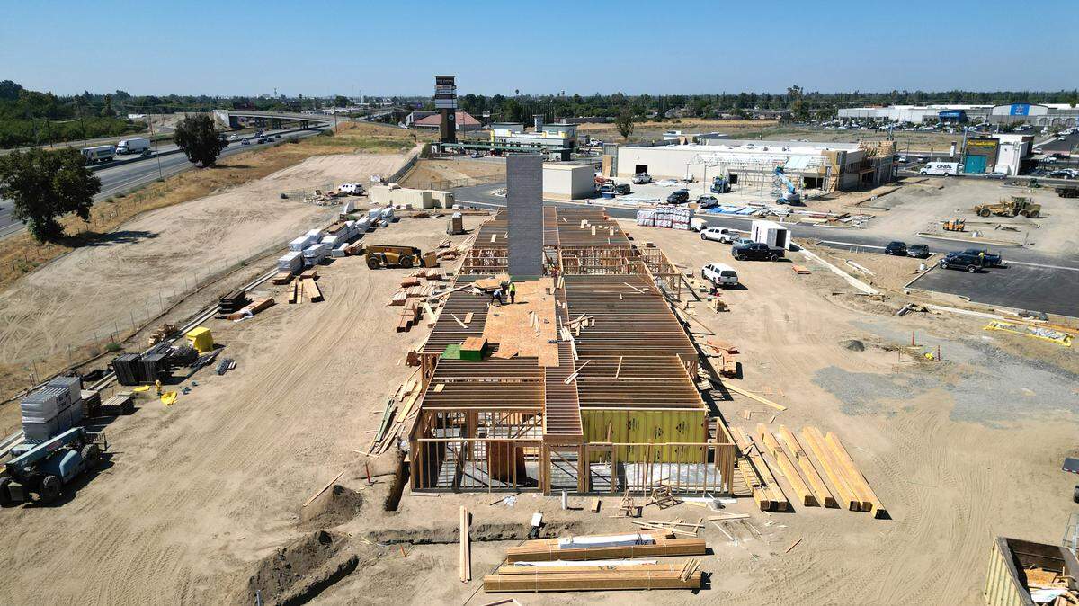 Woodspring Suites hotel is under construction at Ceres Gateway center in Ceres, Calif., Tuesday, August 29, 2023. Tractor Supply is being built, above right.