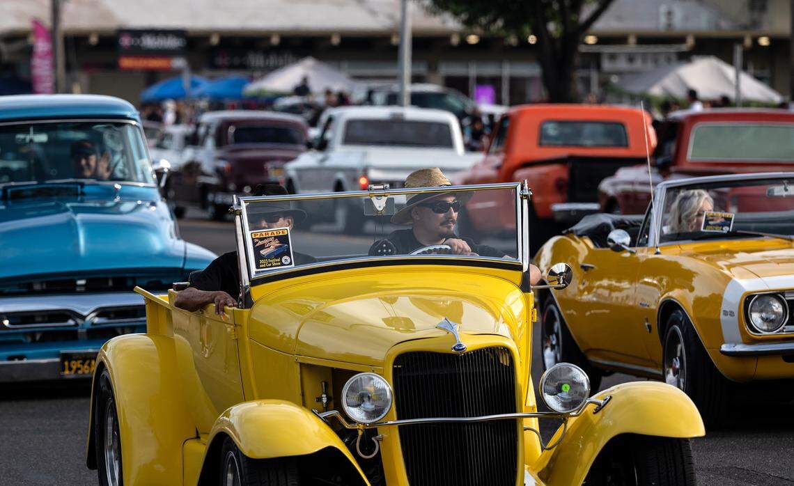 Classic car owners cruise down McHenry Avenue during the Graffiti Parade in Modesto, Calif., Friday, June 9, 2023.