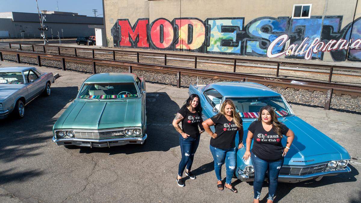 Members of the Chicana Car Club, Christina Berumen, left, Angie Berumen, and Elisa Trevino, right, in Modesto, Calif., on Wednesday, Sept. 8, 2021.