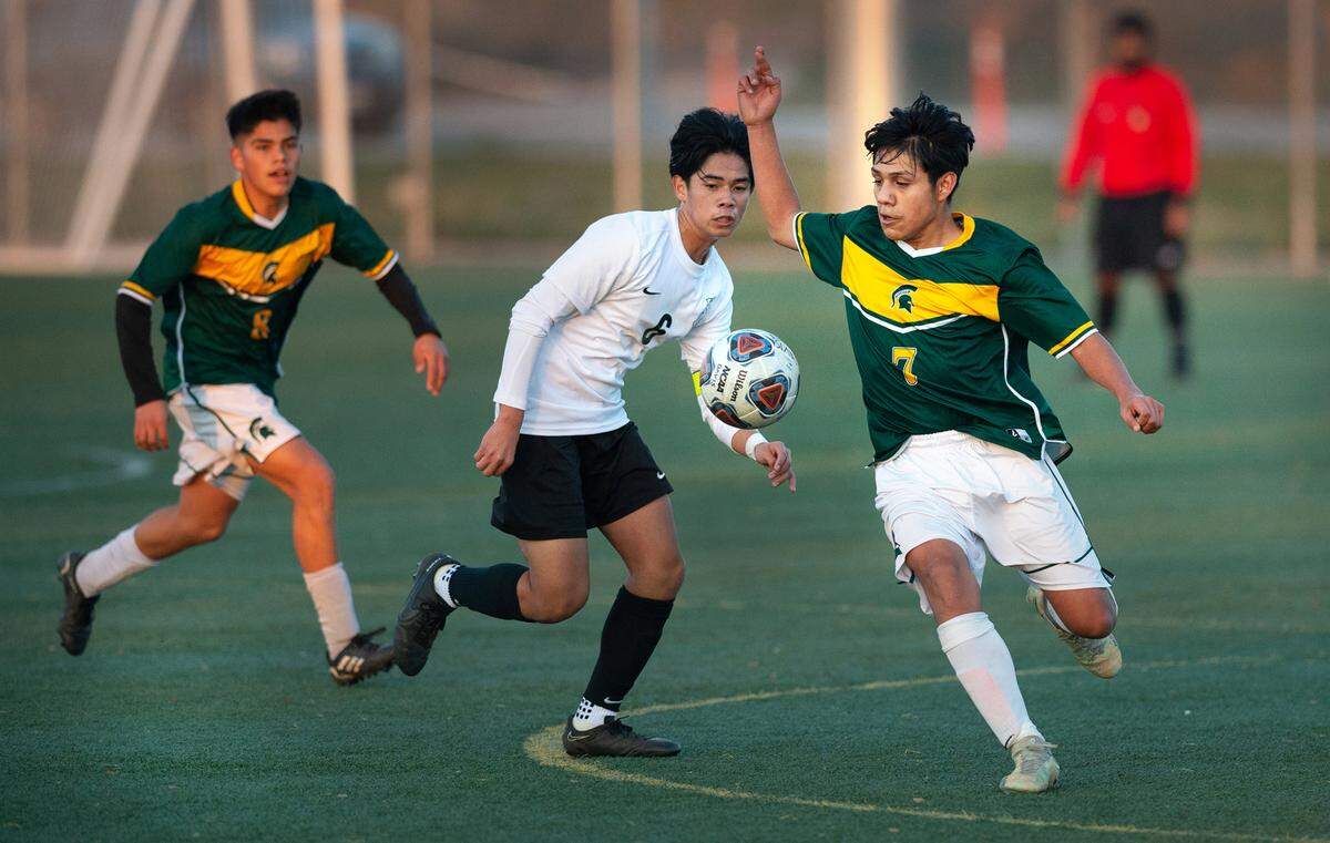 Davis High’s Gabriel Abarca tracks down the ball during a Western Athletic Conference game with Lathrop High at Mary Grogan Park in Modesto, Calif., Friday, Dec. 16, 2022.
