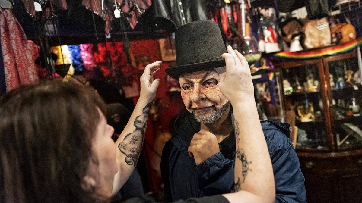 Owner Dana Walters fits a costume on Faruk Attayib at Daydreams and Nightmares in Modesto, Calif., Thursday, Oct. 17, 2019.