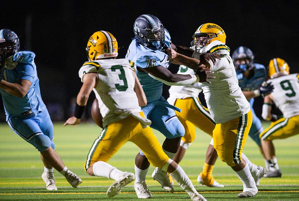 Downey’s Deontae Huley gets past Tracy lineman Noah Bennett and pressures quarterback Cameron Ross during the nonleague game at Downey High School in Modesto, Calif., on Friday, September 16, 2022.