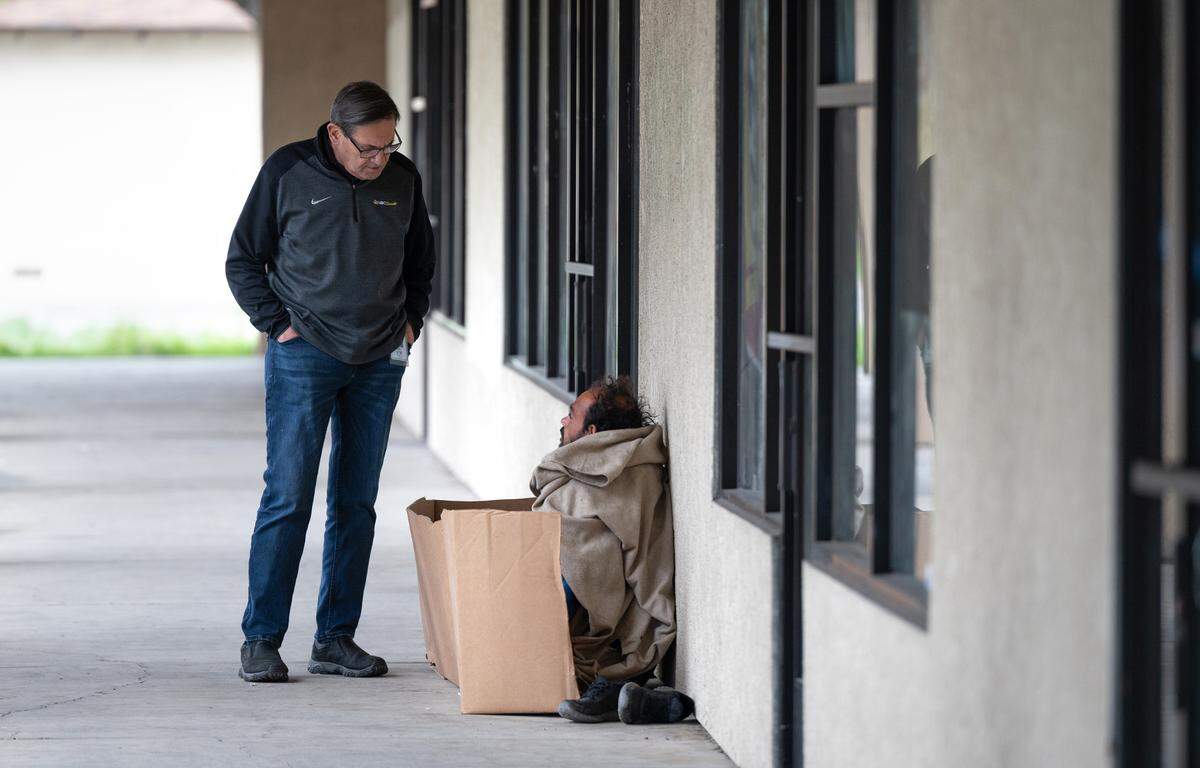 Modesto councilmember Nick Bavaro talks with homeless resident Stefan Zuckerman in Modesto, Calif., Wednesday, March 29, 2023.