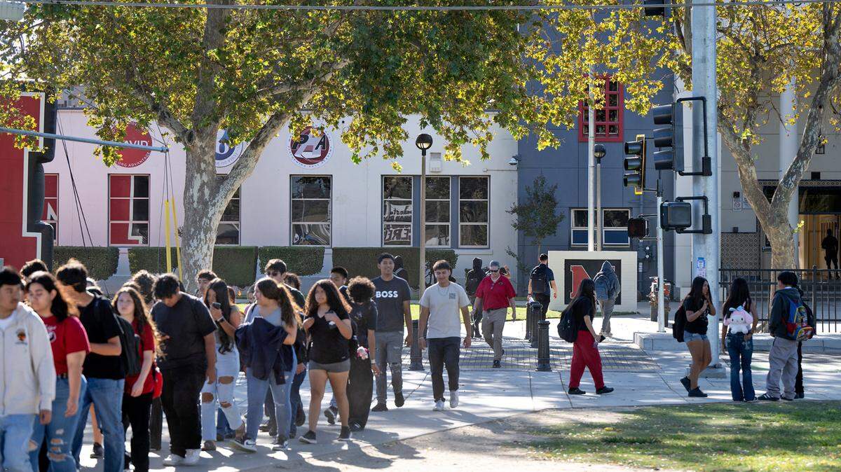Students cross Paradise Road outside Modesto High School in Modesto, Calif., Tuesday Oct. 8, 2024. 