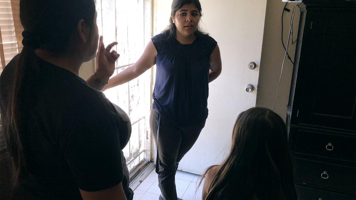 Kim Martinez, a community organizer with Faith In the Valley, Stanislaus, speaks with tenants in a rental apartment about their concerns Monday afternoon, May 14, 2018, in west Modesto, Calif.