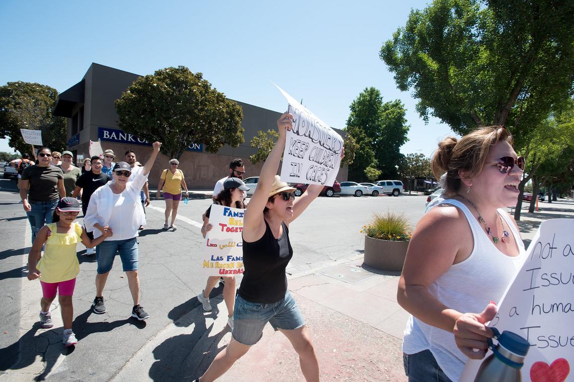 People march along J Street during the Families Belong Together march and protest in Modesto, Calif., Saturday, June 30, 2018.