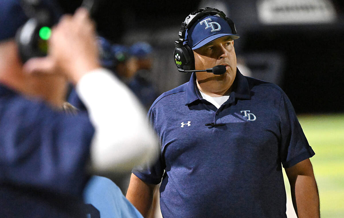 Downey coach Jeremy Plaa watches the action from the sideline during the game with Lincoln at Downey High School in Modesto, Calif., Friday, August 18, 2023. 