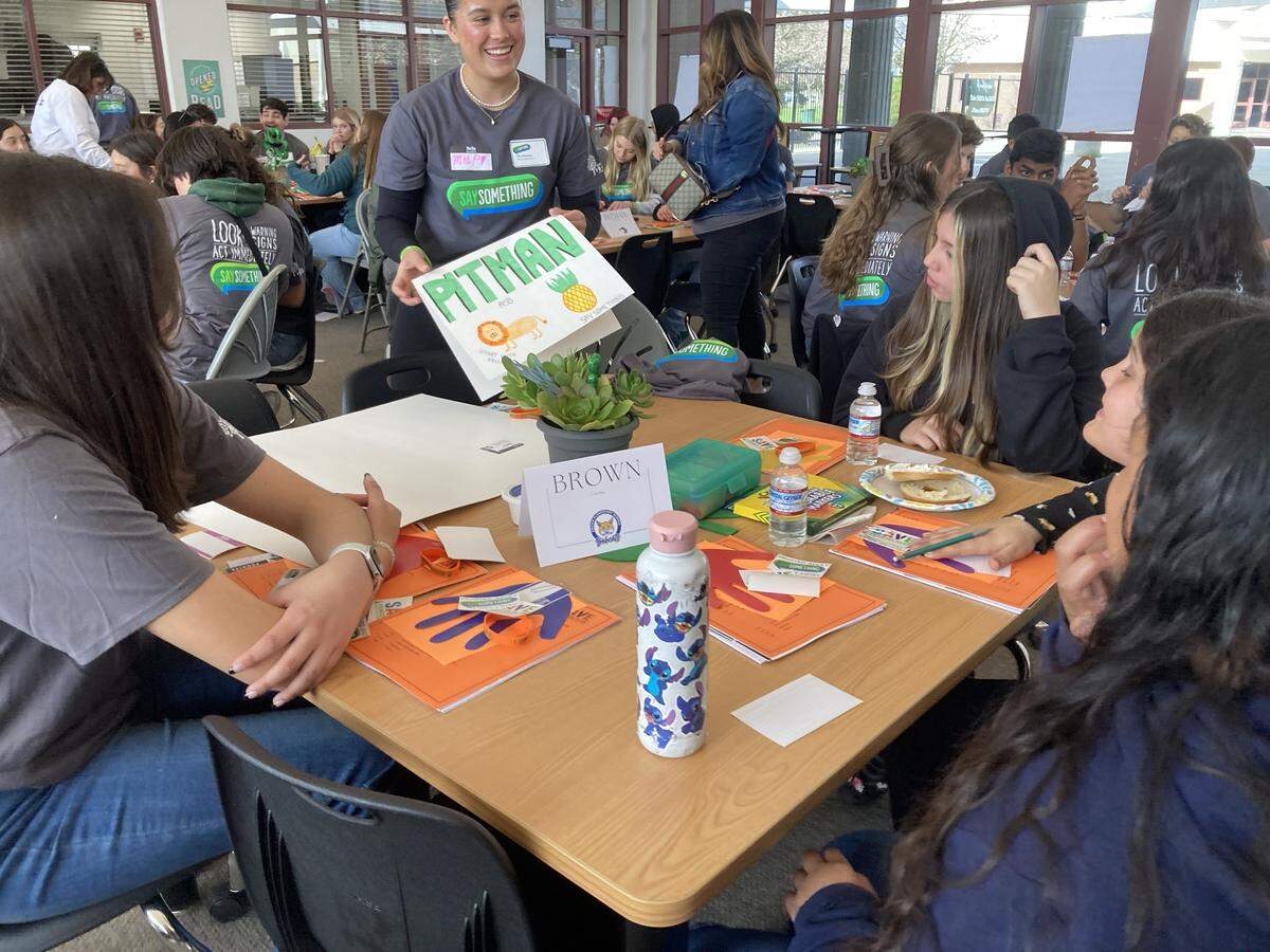 Mia Peterson, alumni volunteer, speaks with students at the CalSTOP SAVE Promise Club Youth Leadership Training Workshop on March 9, 2023 at Pitman High School.
