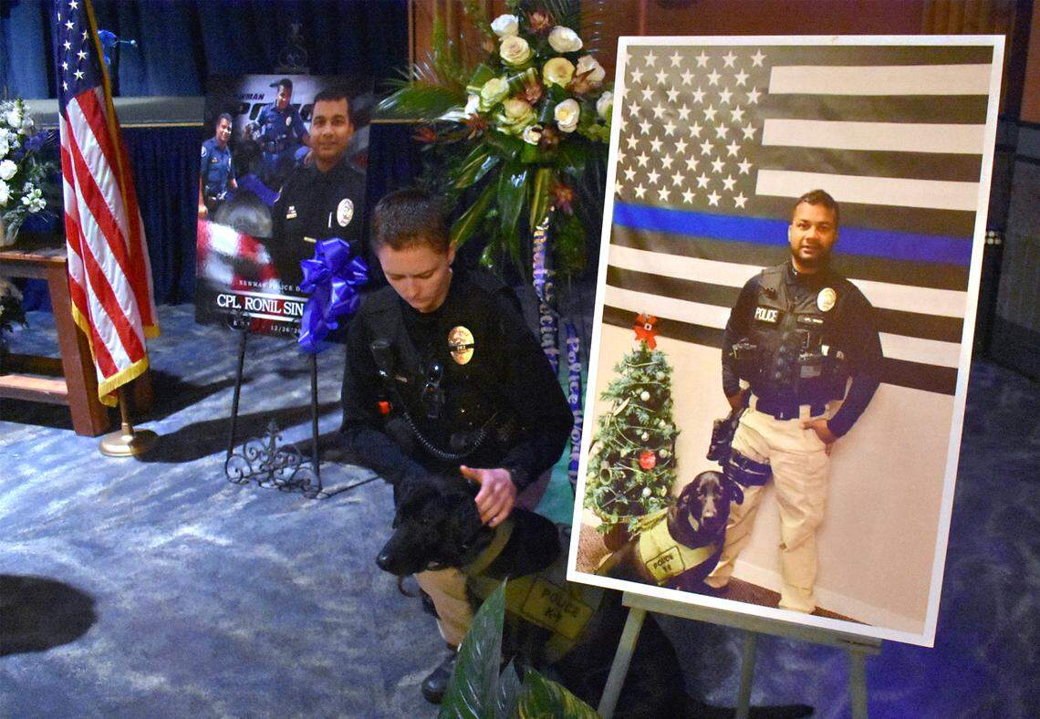 Newman Police Cpl. Ashley Williams is pictured with Sam, Ronil Singh’s K-9 at the West Side Theatre in downtown Newman, Calif. on Friday morning January 4, 2018. A viewing was held in Newman this morning for Singh, the police corporal that was killed during a traffic stop on December 26th.