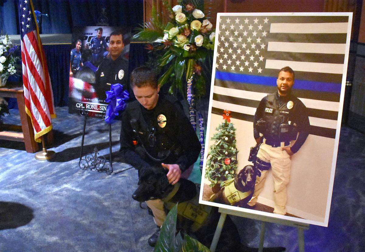 Newman Police Cpl. Ashley Williams is pictured with Sam, Ronil Singh’s K-9, at the West Side Theatre in downtown Newman, Calif. on Friday morning January 4, 2019.