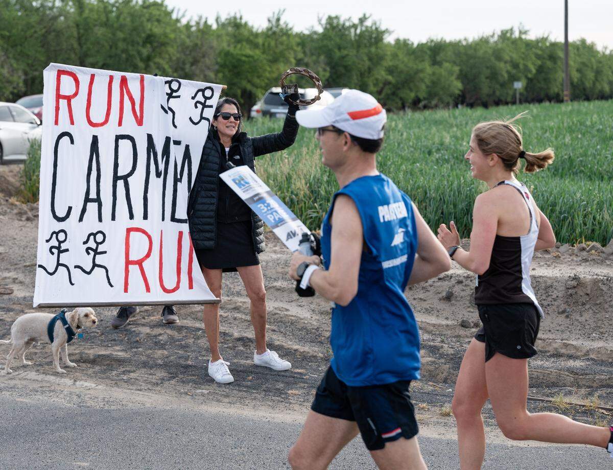 Rose Persak cheers on family friend Carmen Fahlen, right, during the Modesto Marathon in Modesto, Calif., on Sunday, March 27, 2022. Fahlen finished in third place with a time of 3:26:13.