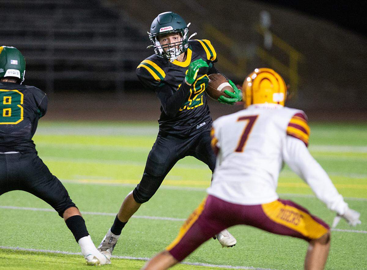 Davis’ Kaylon Roote runs the ball during a Western Athletic Conference game with Los Banos at Downey High School in Modesto, Calif., on Friday, September 23, 2022.