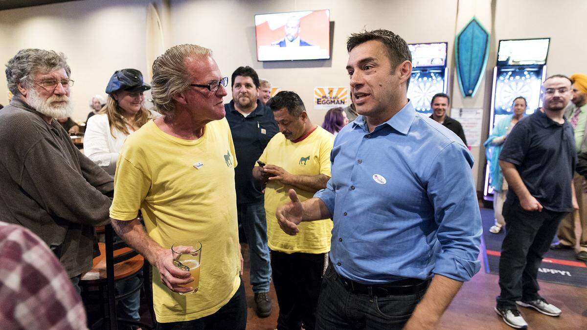 U.S. Congressional District 10 challenger Michael Eggman talks with supporters including Stephen Guiry, left, during an election night party at Sandude taproom in Modesto Calif., on Tuesday, November 8, 2016.