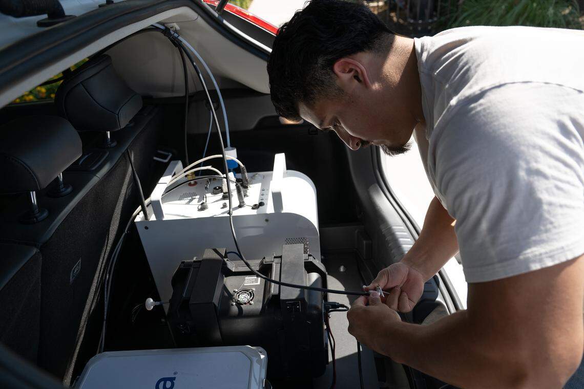 Driver Jesus Cruz prepares air monitoring equipment on the Alcima vehicle in Modesto on Friday, Aug. 29, 2025.