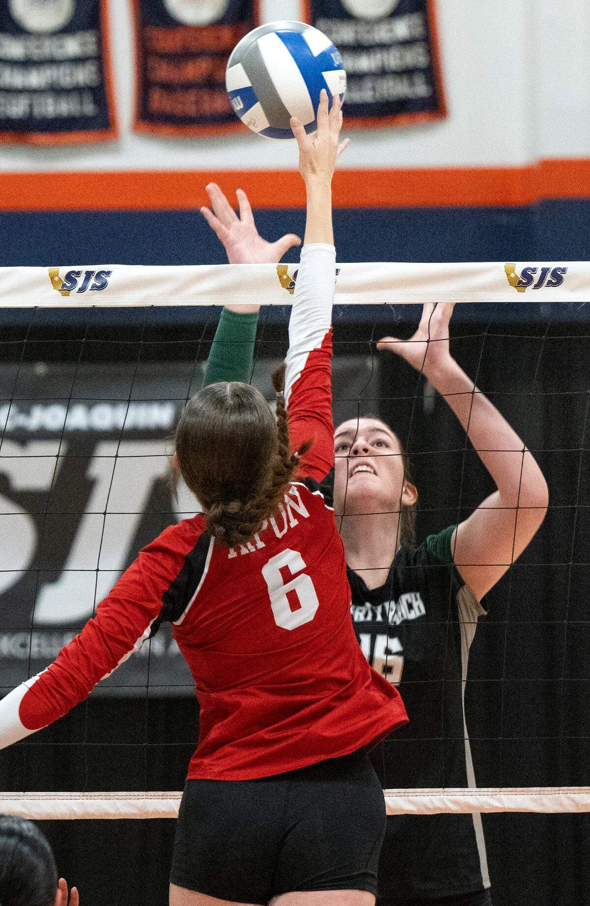 Ripon’s Olivia Neuman (6) tries to push the ball past Liberty Ranch defender Rachel Smith during the Sac-Joaquin Section Division IV volleyball championship match at Cosumnes River College in Sacramento, Saturday, Nov. 9, 2024.