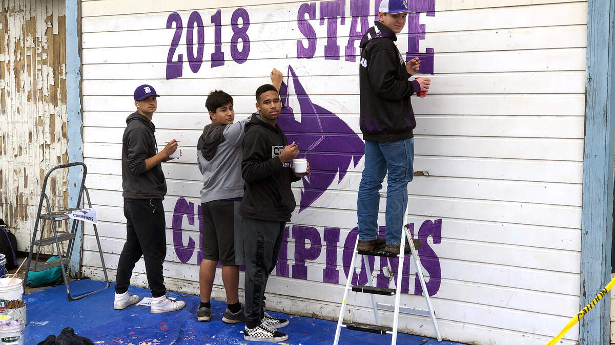Members of the Denair High School football team painted a mural near the Denair, Calif. campus to celebrate their Division VII state championship in December 2018. They are, from left, Carlo Morales, Austin Richards, Elvis Silva and Stephin Winston.