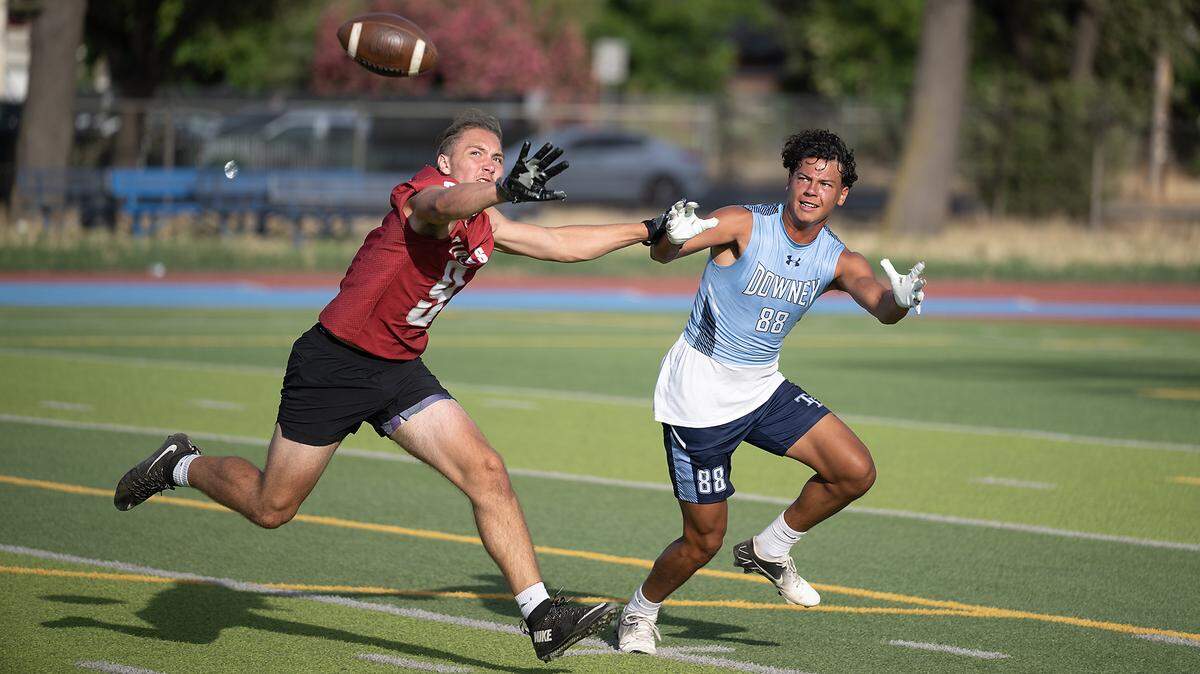 Patterson’s Matt Wilcox, left, defends on Downey’s Jason Sloan during varsity passing league at Downey High School in Modesto, Calif., Tuesday, June 27, 2023.
