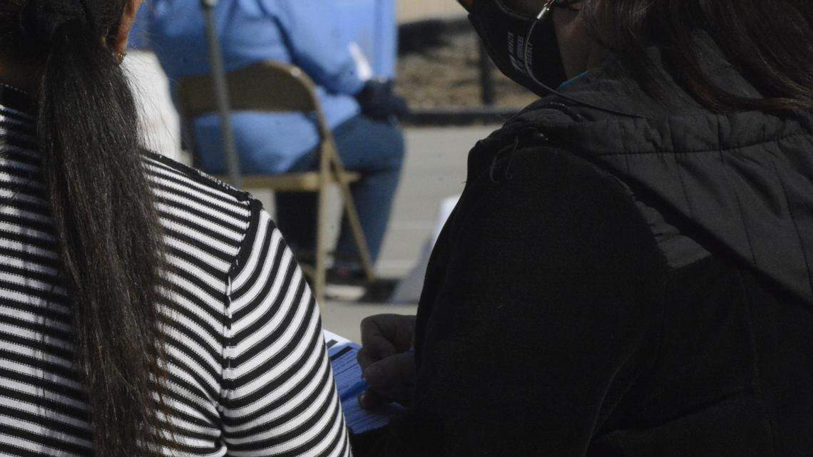 A woman fills out an information sheet at a COVID-19 vaccination clinic at the Modesto Gospel Mission on Monday, April 5, 2021 in Modesto, California.