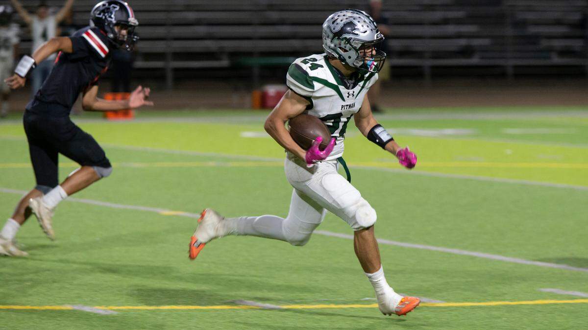Joey Stout, 24, of Pitman High works his way up field against Modesto High Friday Oct. 21, 2022.