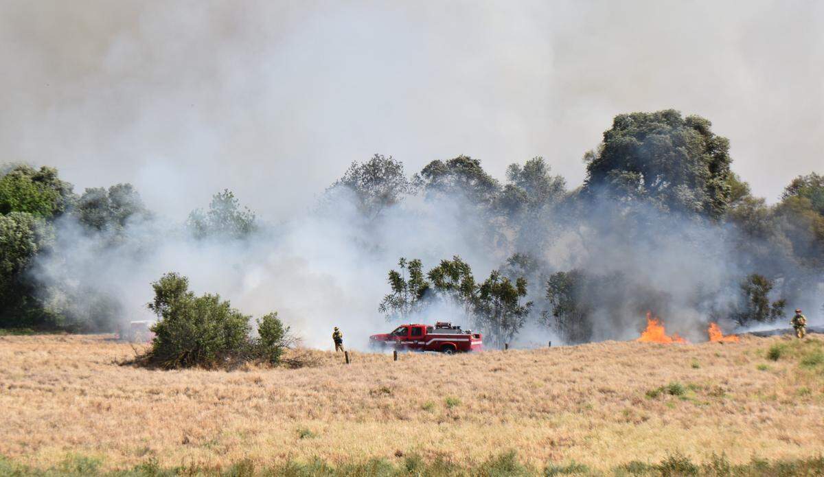 Firefighters from across Stanislaus County battle a vegetation fire near Modesto’s airport neighborhood on Monday afternoon, May 2, 2022.