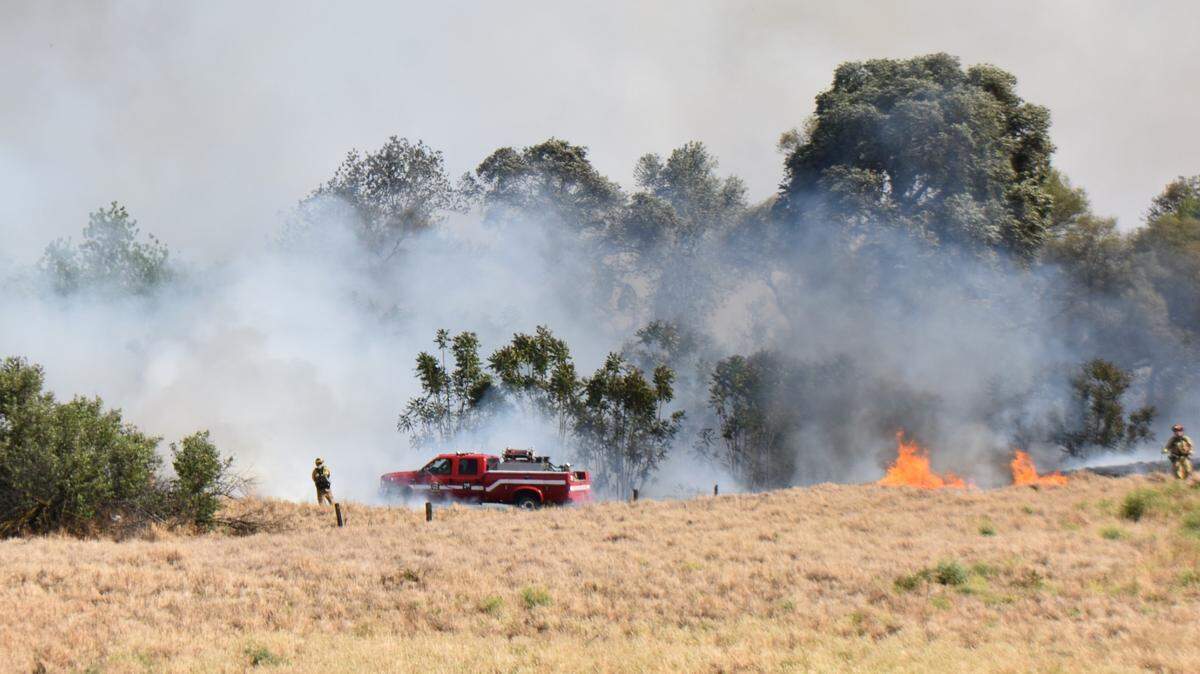 Firefighters from across Stanislaus County battle a vegetation fire near Modesto’s airport neighborhood on Monday afternoon, May 2, 2022.