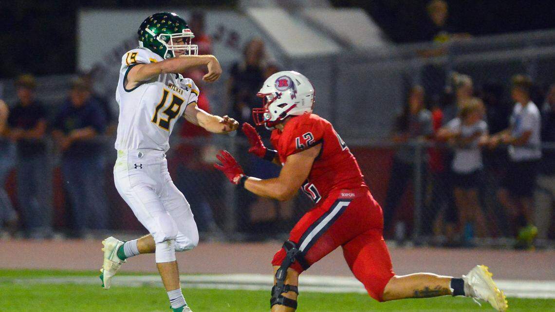 Hilmar quarterback Cameron Moak throws while beinf pressured by Ripon’s Ethan Day during a football game between Hilmar and Ripon High School at Ripon High School in Ripon CA on September 24, 2021