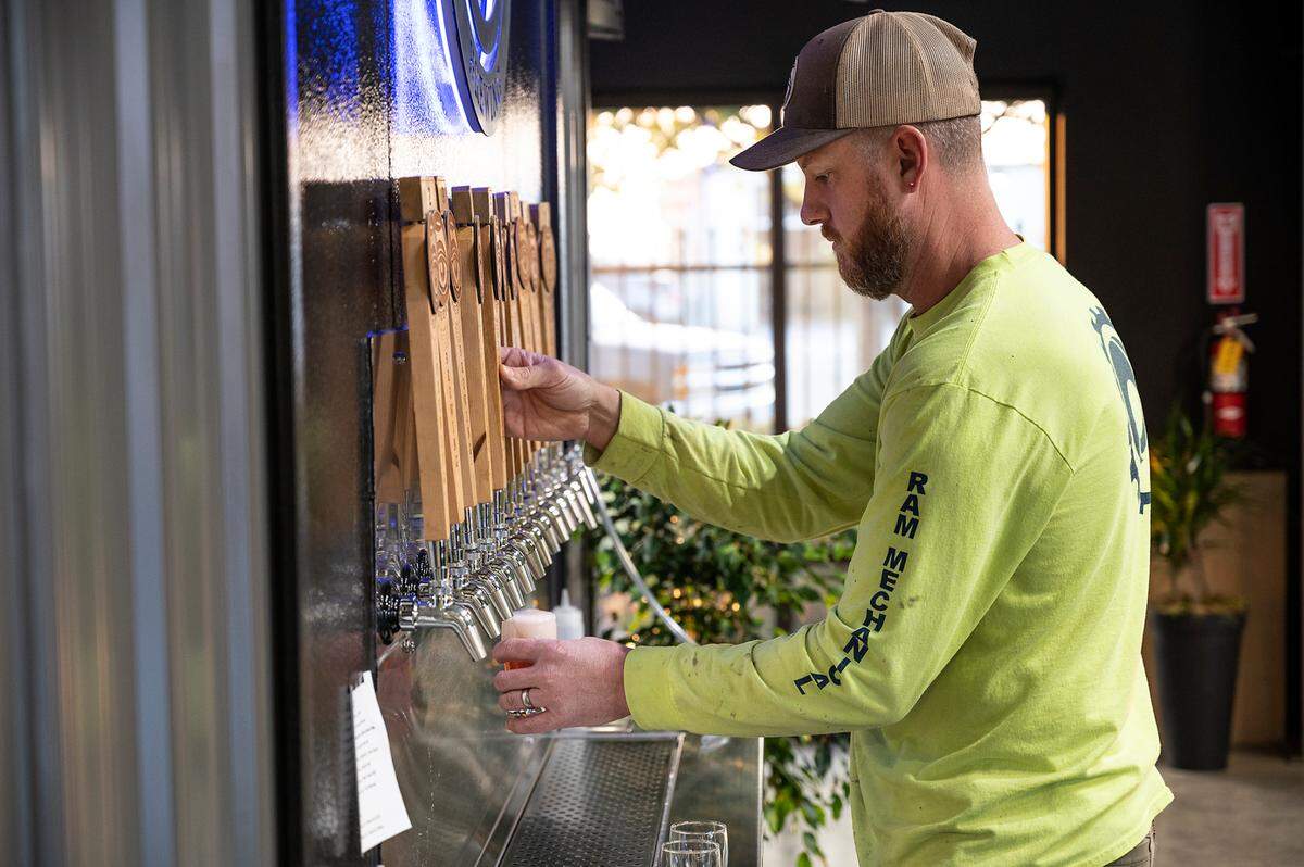 Co-owner and brewer Alan Atkins taps some sample beers at Five Eye Brewing in Ceres, Calif., on Tuesday, Nov. 23, 2021.