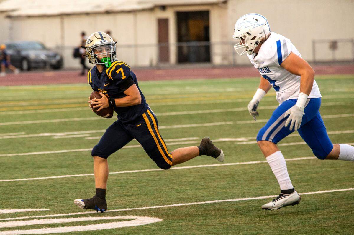 Scout Silva, 7, of Turlock is chased down by Rocklin’s Chase Baker, 9, during the first half of their game at Turlock High Aug. 23, 2024.