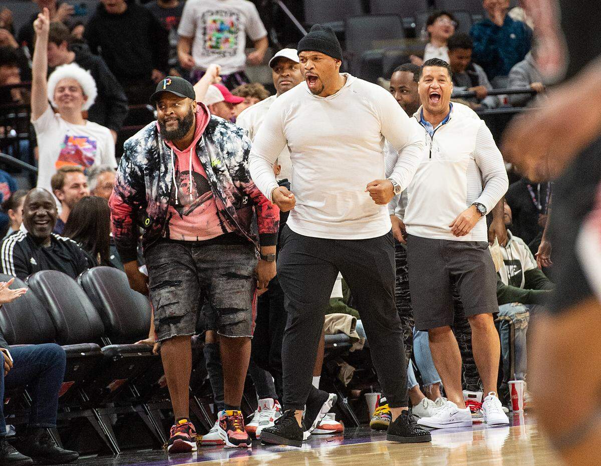 Modesto Christian alum Chuck Hayes, middle, celebrates a basket with others in the audience during a fourth quarter Crusader comeback run in the boys Open Division CIF State Basketball Championship game with Centennial at Golden 1 Center in Sacramento, Calif., on Saturday, March 12, 2022. Centennial held off MC for the 59-50 victory.