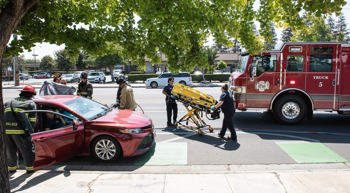 Modesto Fire and paramedics assist a motorist after a collision on Standiford Avenue in Modesto, Calif., Friday, Sept. 6, 2022.